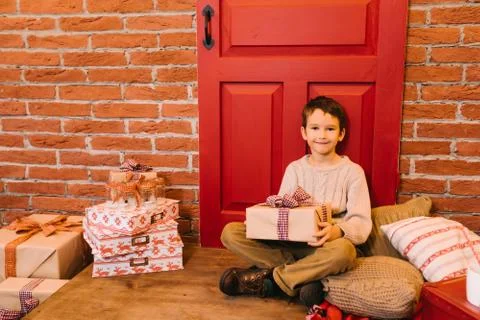 The boy opens a gift Stock Photos