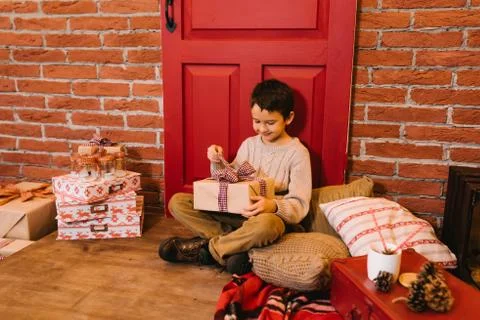 The boy opens a gift Stock Photos