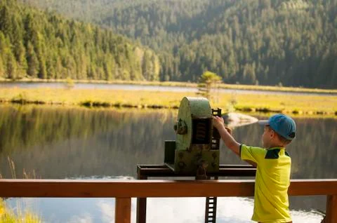 Boy opens the locks at a lake by hand Stock Photos