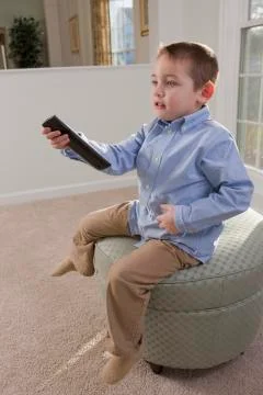 Boy operating a remote control and signing Stock Photos