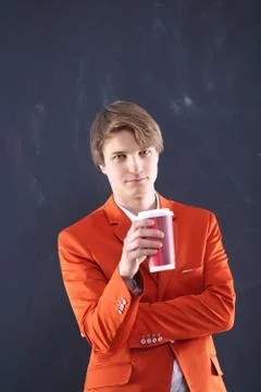 Boy in the orange jacket with a cup of coffee  Stock-Fotos