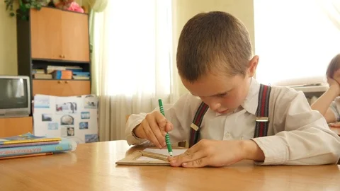 Boy Orphan does Math Exercises at the Table in Class Room, Orphanage in Ukraine Stock Footage 108162008