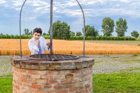 Boy over well Stock Photos