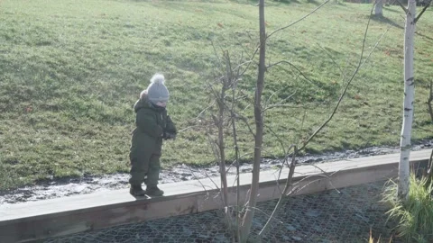 A boy in overalls and a winter hat Stock-Footage 143243684