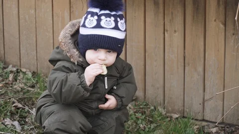 Boy in overalls eats cookies Stock-Footage 128686860
