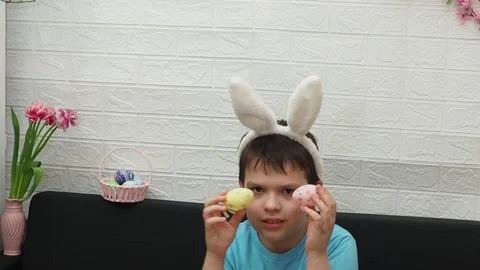 A boy with paints an Easter egg. Preparing for Easter. 스톡 동영상 173748949