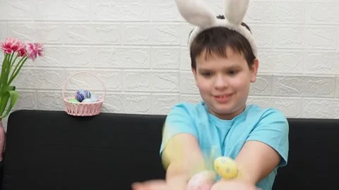 A boy with paints an Easter egg. Preparing for Easter. Stock Footage 173749137