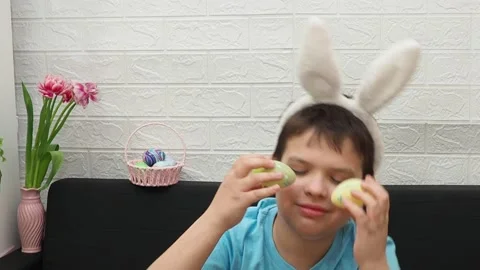 A boy with paints an Easter egg. Preparing for Easter. 스톡 동영상 173749248