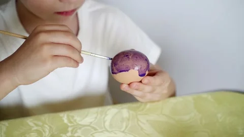 A boy paints Easter eggs and prepares to celebrate Easter Stock Footage 151007011