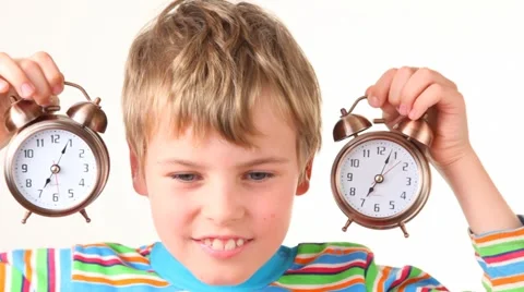Boy with pair of ringing alarm clocks near his ears Stock Footage 980978
