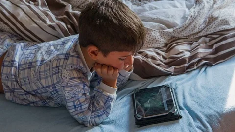 Boy in pajamas with a tablet Stock Footage 75614209