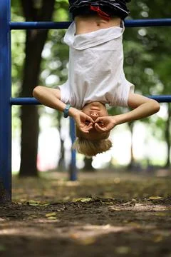 Boy in the park on horizontal bars Stock Photos