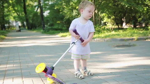 A boy in the park with a scooter Stock Footage 157417380