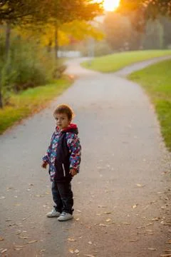 Boy in the park on sunset time Stock Photos