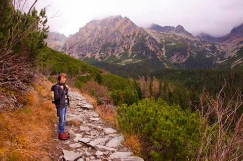 Boy on the Path in Mountains Фото