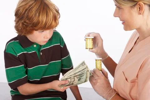 Boy Paying for Medication Stock Photos