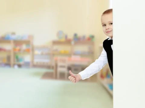 Boy peeks out from behind the banner Stock Photos