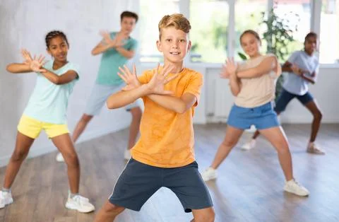 Boy perform choreographic exercises and teach energetic social dance waacking Stock Photos