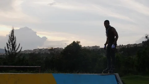 Boy performing one foot trick with rollerblades Stock Footage 113109330