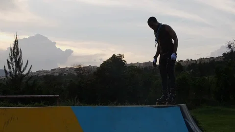 Boy performing one foot trick with rollerblades Stock Footage 113109471