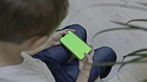 A boy a phone with a green screen Stock Footage 297654542