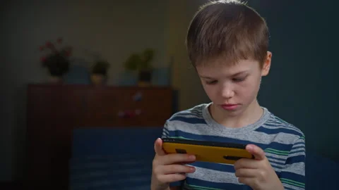 A boy with a phone in his hand. Stock Footage 302877430