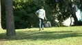 Boy with phone leaves the park HD Footage