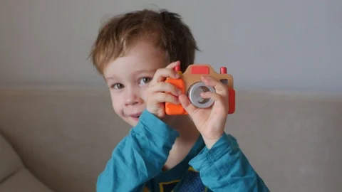 Boy photographing with a toy camera Stock Footage 87184520