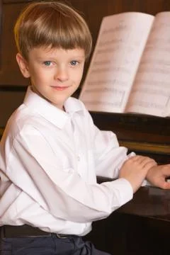 Boy piano. Piano player. Stock Photos