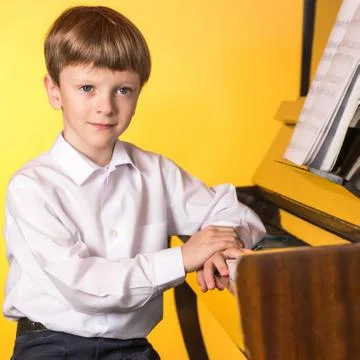 Boy piano. Piano player. Stock Photos