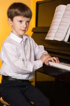 Boy piano. Piano player. Stock Photos