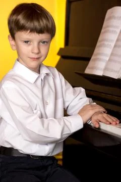 Boy piano. Piano player. Stock Photos
