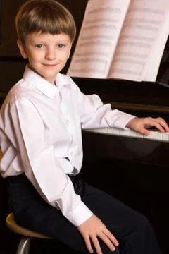 Boy piano. Piano player. Stock Photos