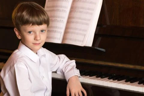 Boy piano. Piano player. Stock Photos