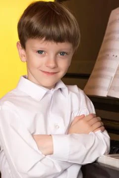 Boy piano. Piano player. Stock Photos