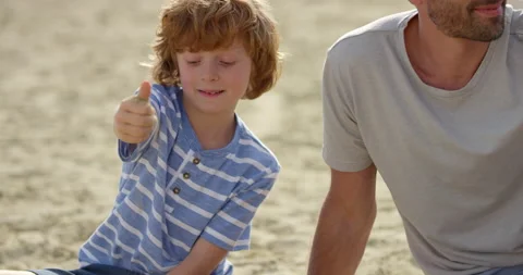 Boy Picking Up A Hand Full Of Sand Stock Footage 144315014