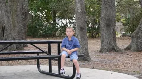 Boy on a picnic bench Stock Footage 10737286