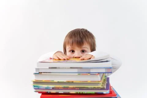 Boy with a pile of books Stock Photos