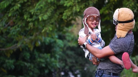 Boy with pilot glasses play fly with his dad at park Stock Footage 220556181