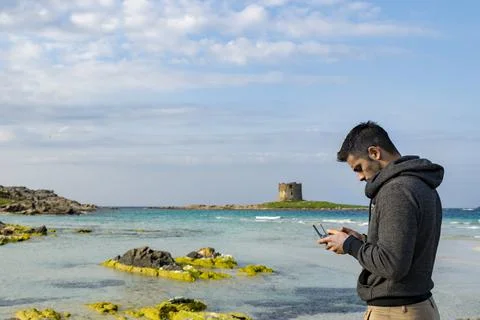 A boy pilots a drone from the beach Stock Photos