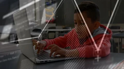 Boy placing hands on keyboard and typing, charts and code overlaying laptop for Stock Footage 331214065
