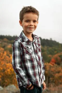 Boy in Plaid Shirt Smiling on Background of Autumn Landscape Stock Photos