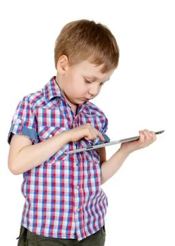 A boy in a plaid shirt with a tablet computer Stock Photos