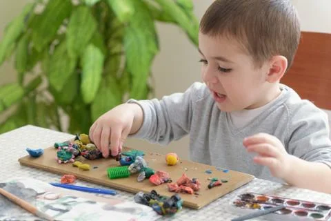 Boy with plasticine Stock Photos