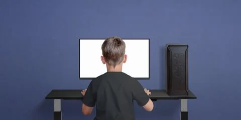 Boy play game on desktop computer. Children in gaming. Isolated monitor displ Stock Photos