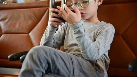 Boy play games on smart phone Stock Footage 69941010
