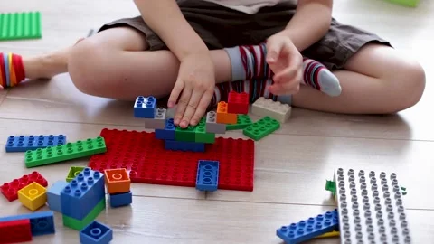 Boy play with multi-colored plastic constructor 스톡 동영상 160164462