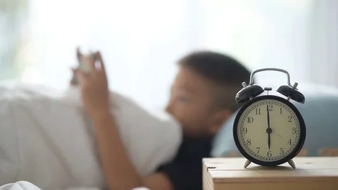 Boy play smart phone on the bed Vídeos de archivo 70013824