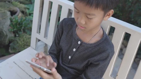 Boy play a smartphone Stock-Footage 105500696