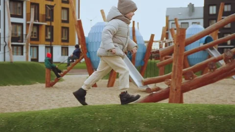 A boy on a playground in a residential complex Stock Footage 323833358